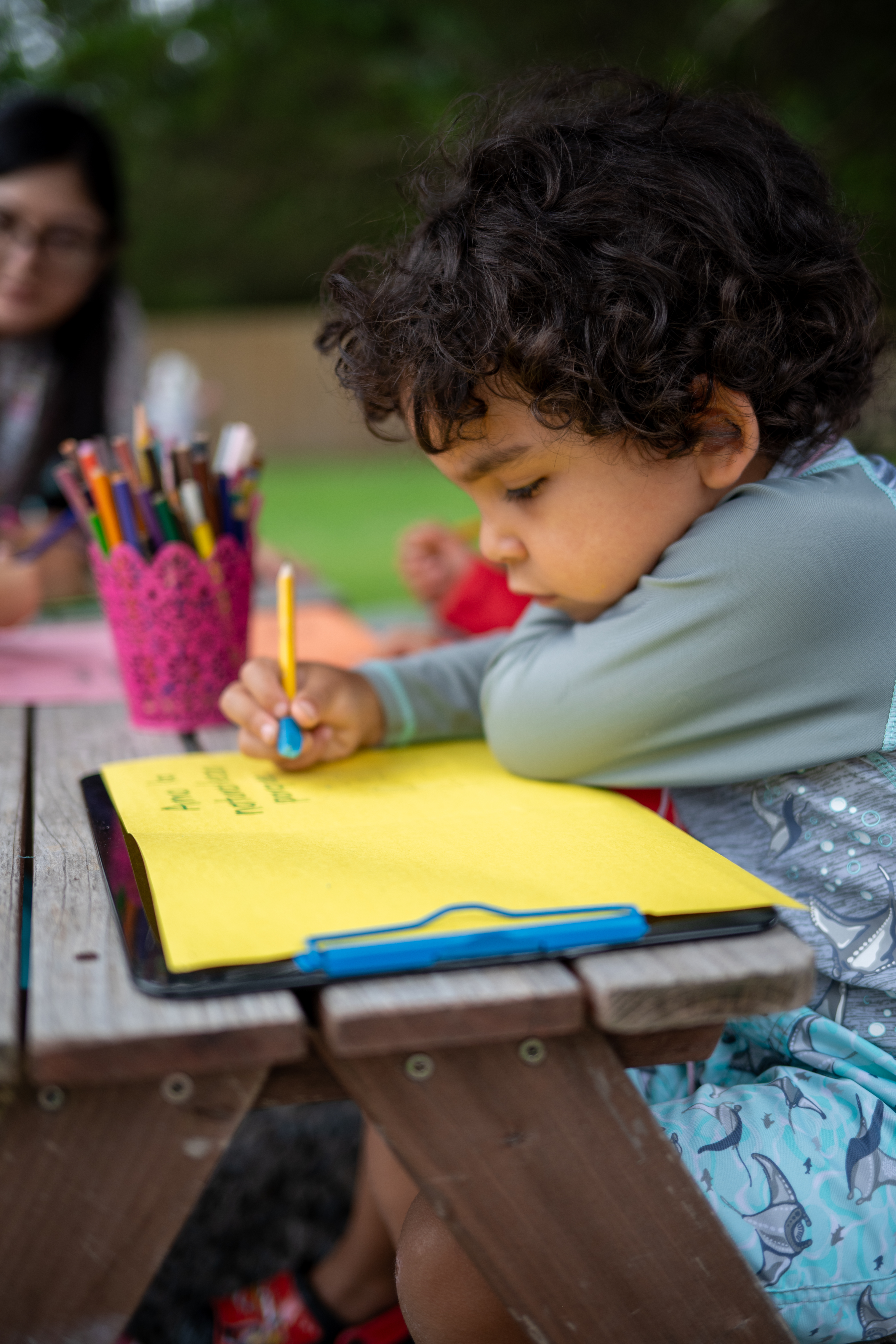 close up of boy writing thank you card